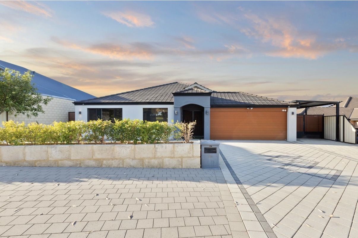 Modern single-storey home with clean exterior and driveway at sunset